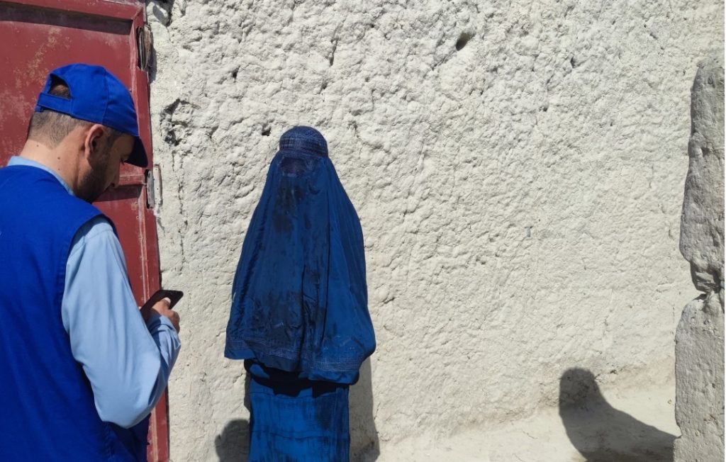 A WMCO staff member visits Fauzia in Tarin Kot.